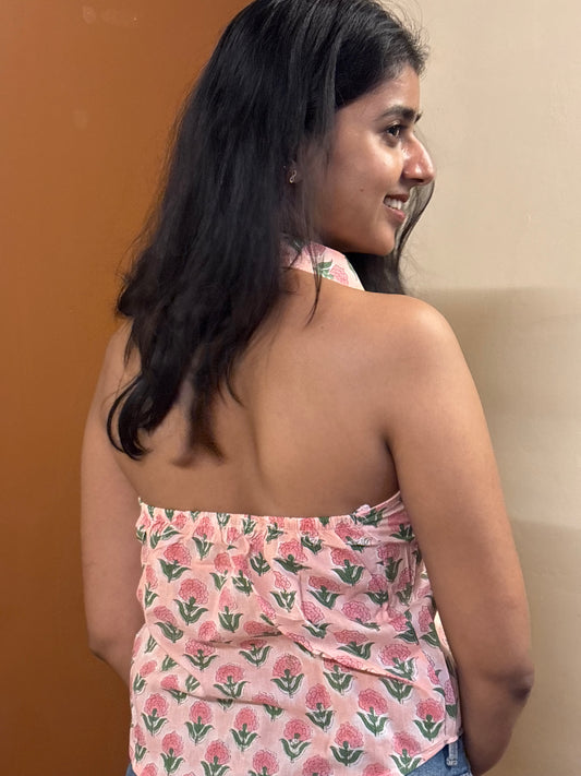 Woman wearing a floral dress against a plain background